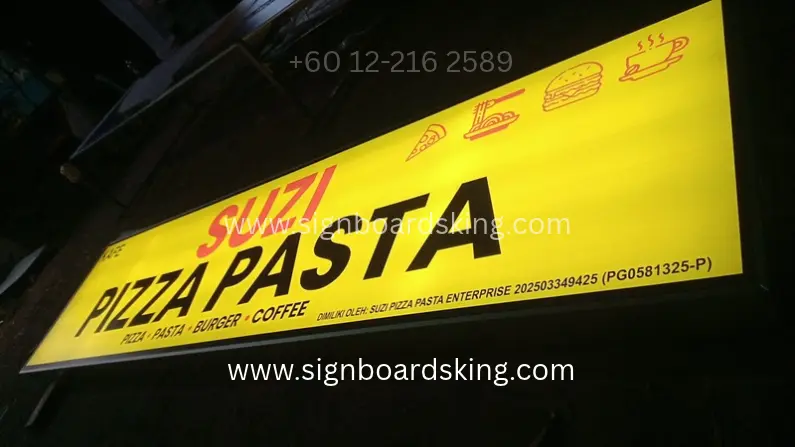 Bright yellow LED Lightbox Signboard for Suzi Pizza Pasta illuminated at night.